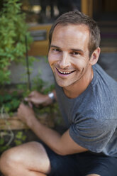 Portrait of happy mid adult man gardening - MASF06055