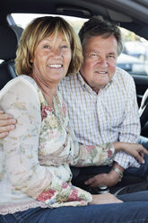 Portrait of happy couple sitting in car - MASF06078