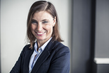 Portrait of happy mature businesswoman standing in office - MASF06138