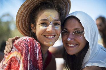 Portrait of smiling friends with face paint at traditional event - CAVF44731
