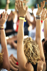 Friends with arms raised enjoying at event - CAVF44740