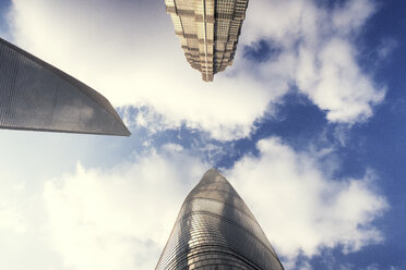 Low angle view of Shanghai Tower with Shanghai World Financial Center and Jin Mao Tower against sky - CAVF44763