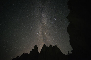 Low angle view of silhouette rock formations against sky with star field at Smith Rock State Park - CAVF44785