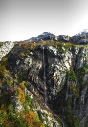 Waterfall over rock formation against clear sky - CAVF44818