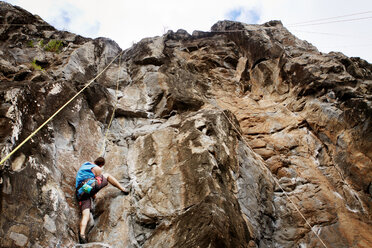 Low angle view of man rock climbing - CAVF44911