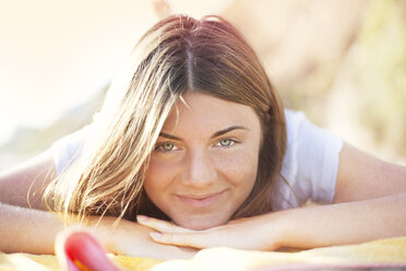 Portrait of woman lying at beach - CAVF45001