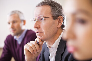 Mature businessman with colleagues in a meeting - MASF06232