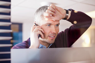 Reifer Geschäftsmann auf Abruf im Büro - MASF06235