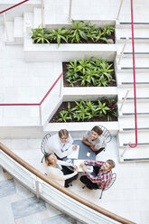 High angle view of four business people sitting at table - MASF06308