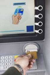 Hand inserting card into ATM - MASF06355