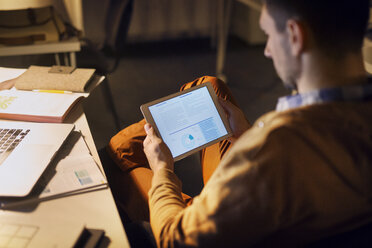 High angle view of man learning through tablet computer in library - CAVF45032