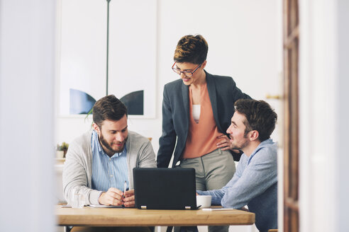 Colleagues talking in office - CAVF45069