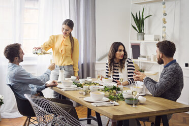 Happy friends enjoying lunch party at home - CAVF45114