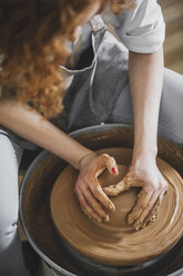 High angle view of female potter molding clay in workshop - CAVF45163