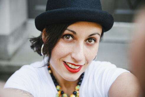 Portrait of smiling woman with hat taking selfie - RTBF01172