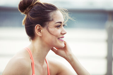 Happy woman looking away while exercising - CAVF45409