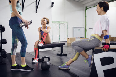 Happy female friends talking in gym - CAVF45521