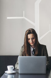 Businesswoman using laptop at restaurant table - CAVF45618