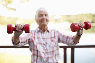 Mature woman and senior man working out in fitness gym stock photo