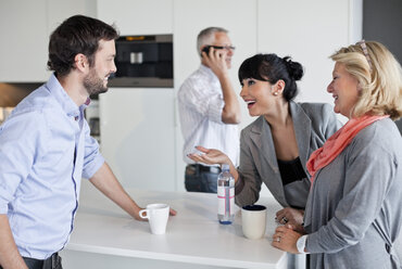 Business people having friendly conversation during coffee break - MASF06615