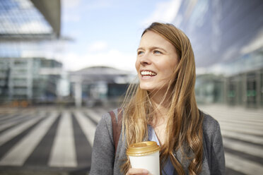 Portrait of smiling young businesswoman with coffee to go - PNEF00613