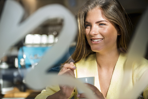 Portrait of smiling young woman in a cafe stock photo