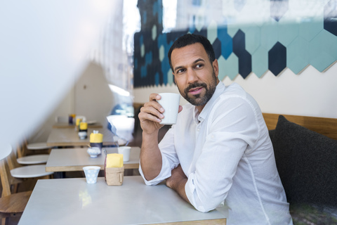 Man drinking coffee in a cafe stock photo