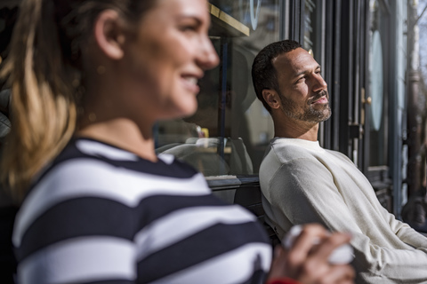 Man and woman relaxing outside a cafe stock photo