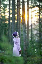 Woman in forest looking up - MASF06711