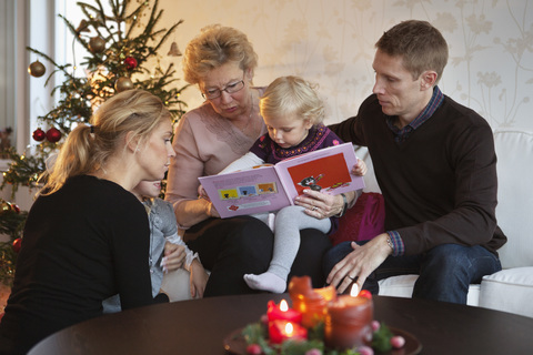 Family reading a book stock photo