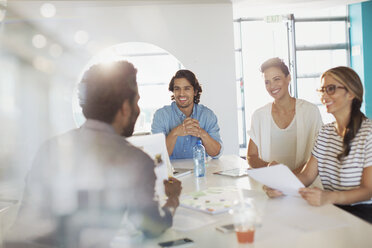 Smiling creative business people brainstorming, planning in conference room meeting - HOXF03456