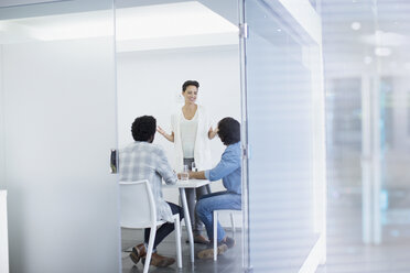 Businesswoman leading conference room meeting - HOXF03484