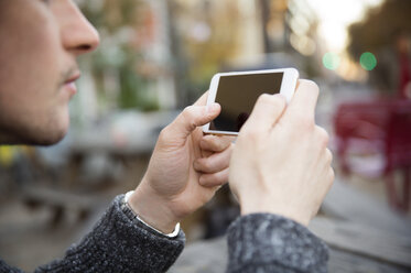 Cropped image of man using mobile phone - CAVF45720