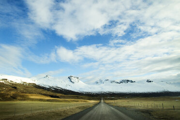 Empty country road amidst field against sky - CAVF45841