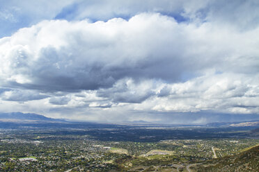 Aerial view of cityscape against cloudy sky - CAVF45851
