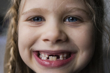 Close-up portrait of happy girl showing teeth - CAVF46033