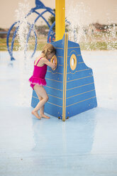 Full length of girl in swimwear enjoying at water park - CAVF46055