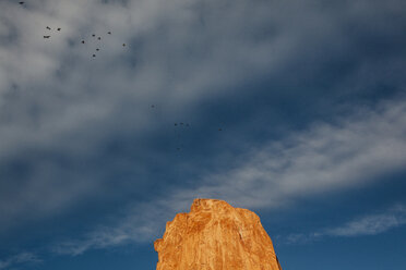 Low angle view of rock formation against cloudy sky - CAVF46357