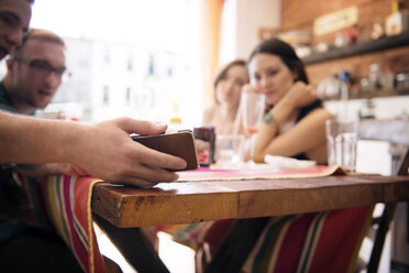 Friends taking selfie at table in home - CAVF46545