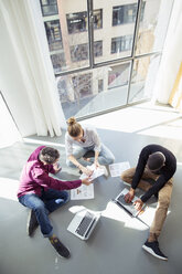 High angle view of business people working by window in office - CAVF47237