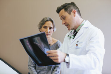 Close-up of doctor explaining x-ray image to patient in medical clinic - CAVF47266