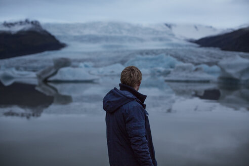 Rear view of man looking at glaciers - CAVF47339