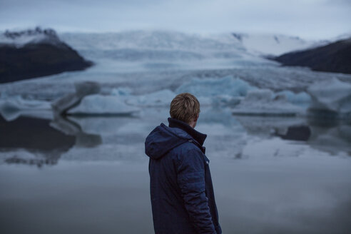 Rückansicht eines Mannes mit Blick auf Gletscher - CAVF47339