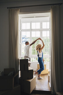 Couple dancing in new house seen through doorway - CAVF47585