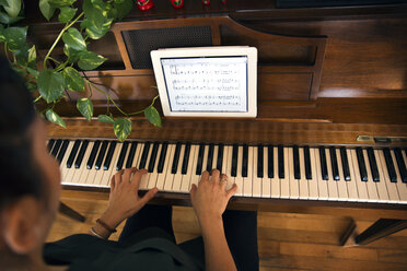 Cropped image of woman playing piano at home - CAVF47777