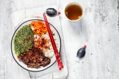 Vegan teriyaki bowl with pulled teriyaki beef made from jackfruit, spinach, rice and carrots stock photo