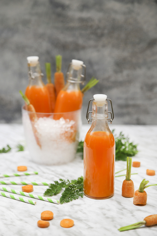 Refreshing carrot juice on marble stock photo