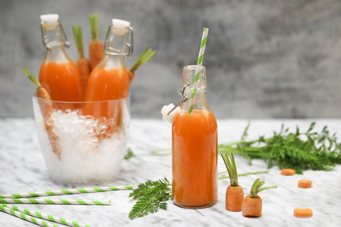 Refreshing carrot juice on marble stock photo
