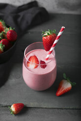 Glasses of strawberry smoothie and strawberries on dark wood - RTBF01206