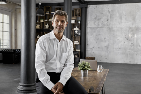 Portrait of mature businessman in loft office stock photo